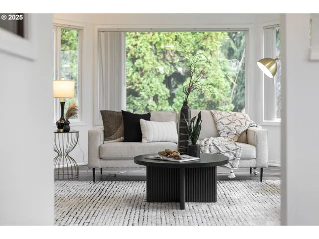 a living room with furniture and a large window