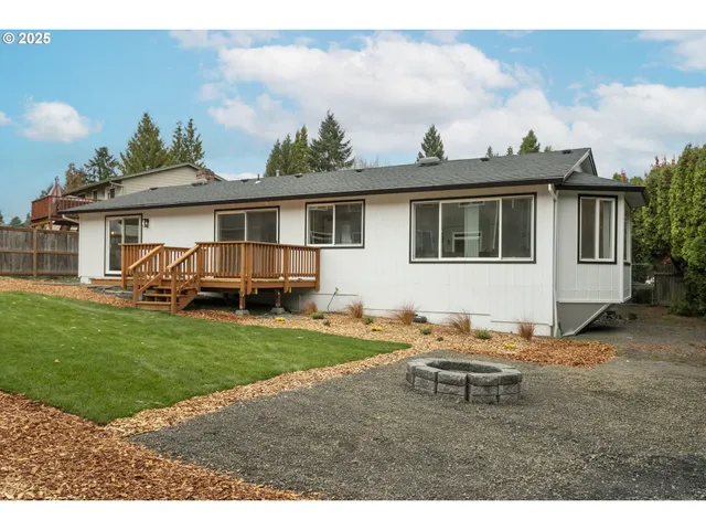 a view of deck with a large window and wooden floor