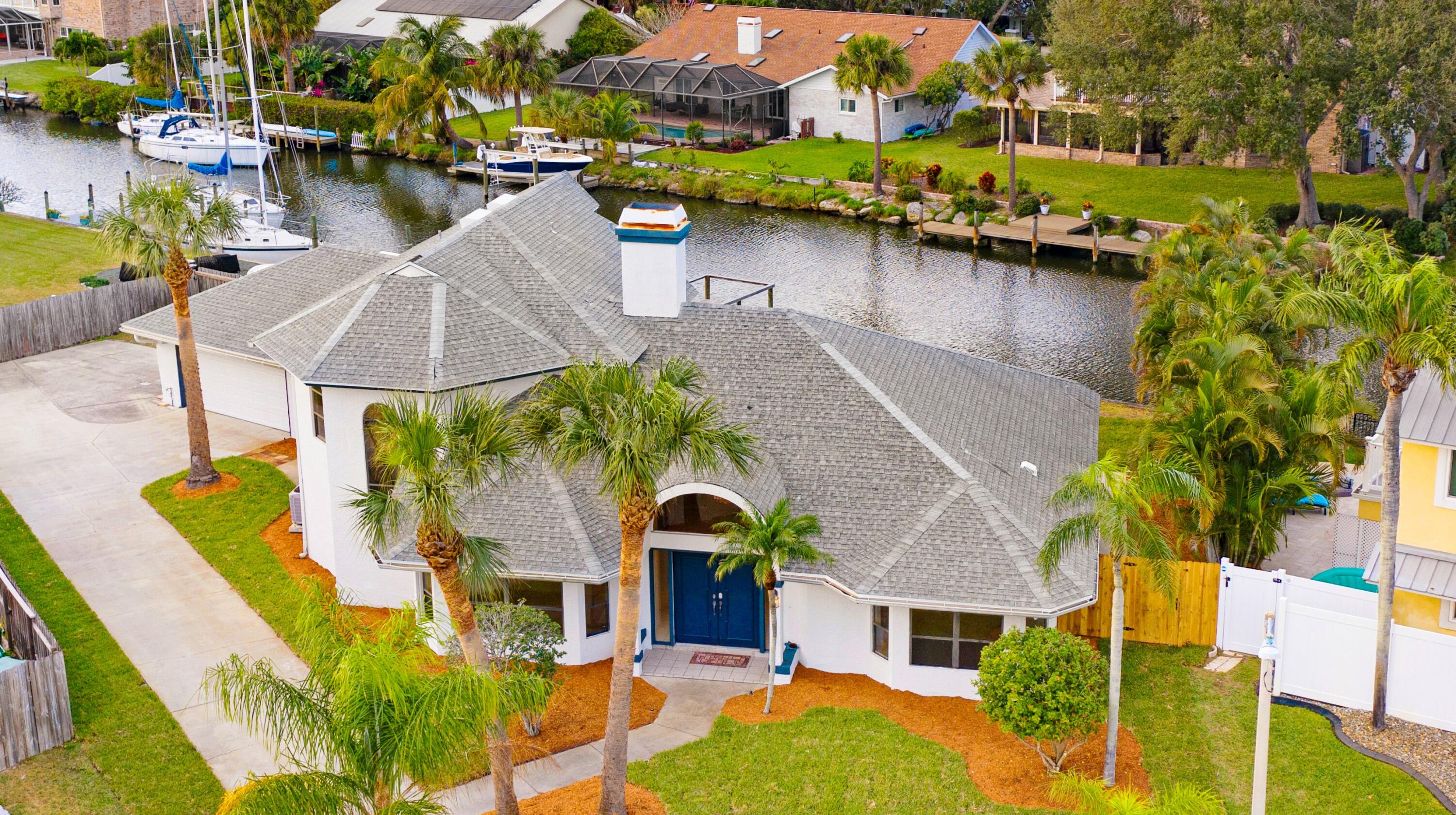 3 Inwood Way Indian Harbour Beach, FL 32937 - Photo 1 of 35 an aerial view of a house with outdoor space pool patio and lake view