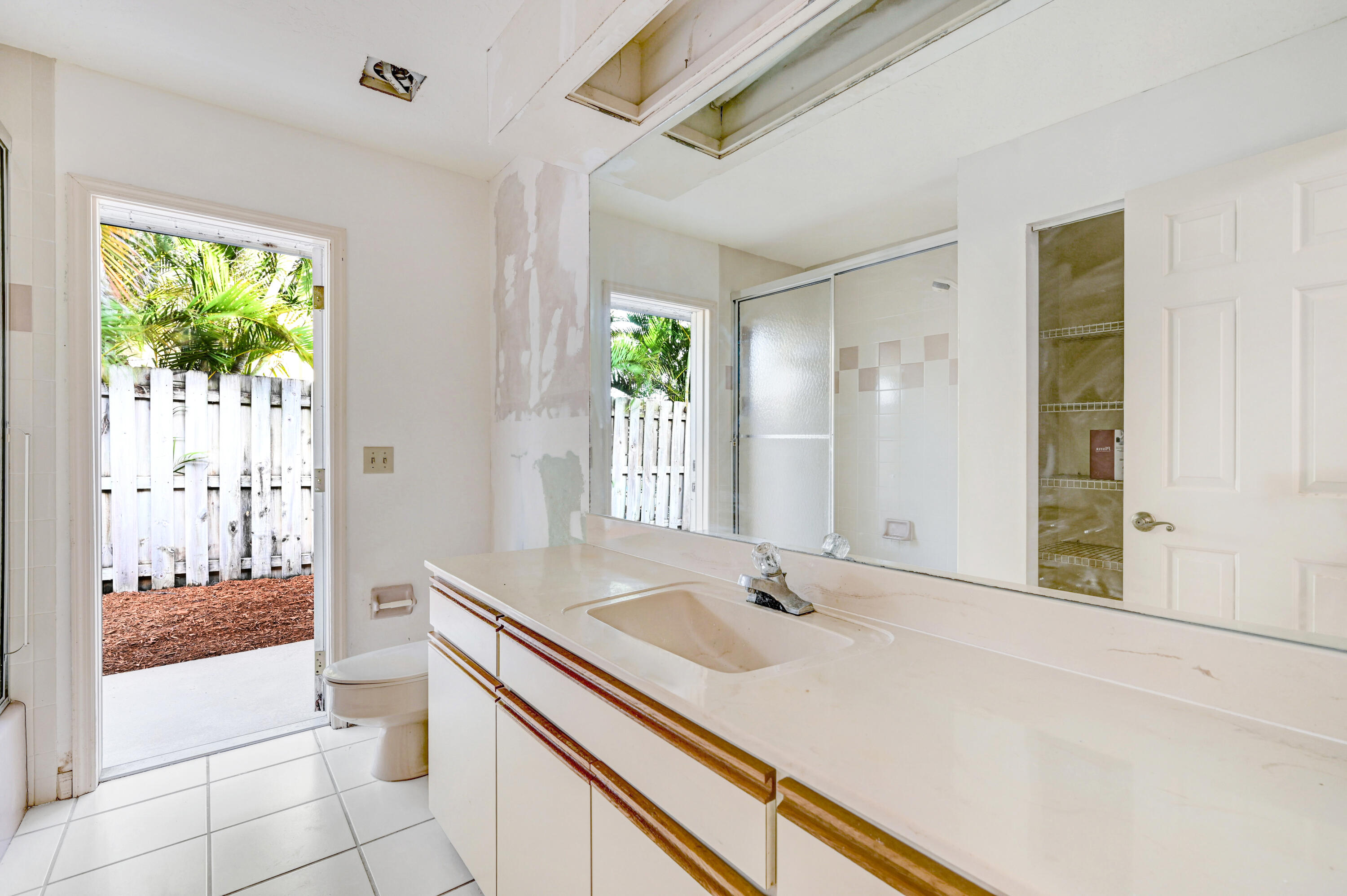 3 Inwood Way Indian Harbour Beach, FL 32937 - Photo 15 of 35 a bathroom with a sink and a large mirror