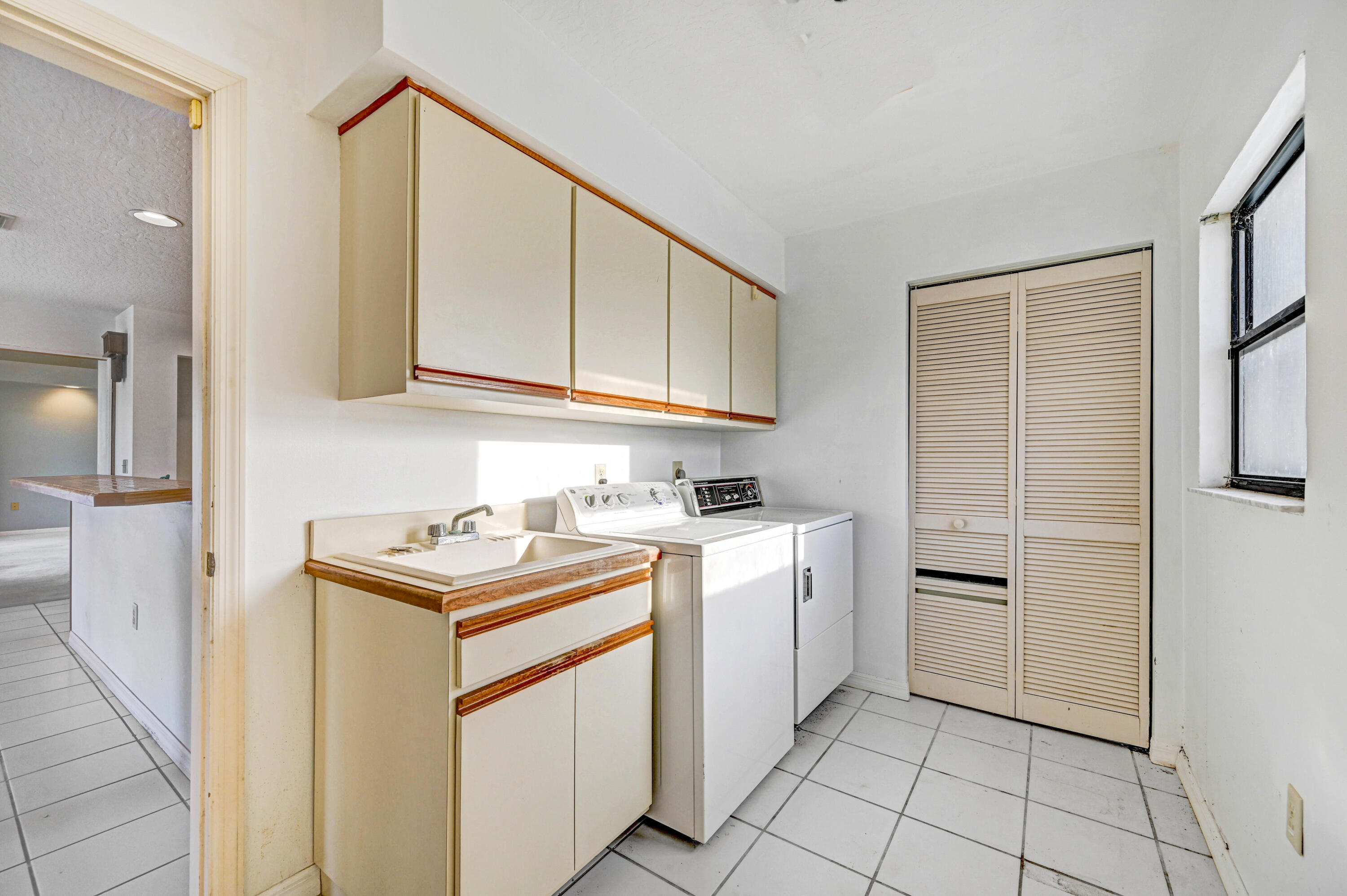 3 Inwood Way Indian Harbour Beach, FL 32937 - Photo 17 of 35 a utility room with cabinets washer and dryer