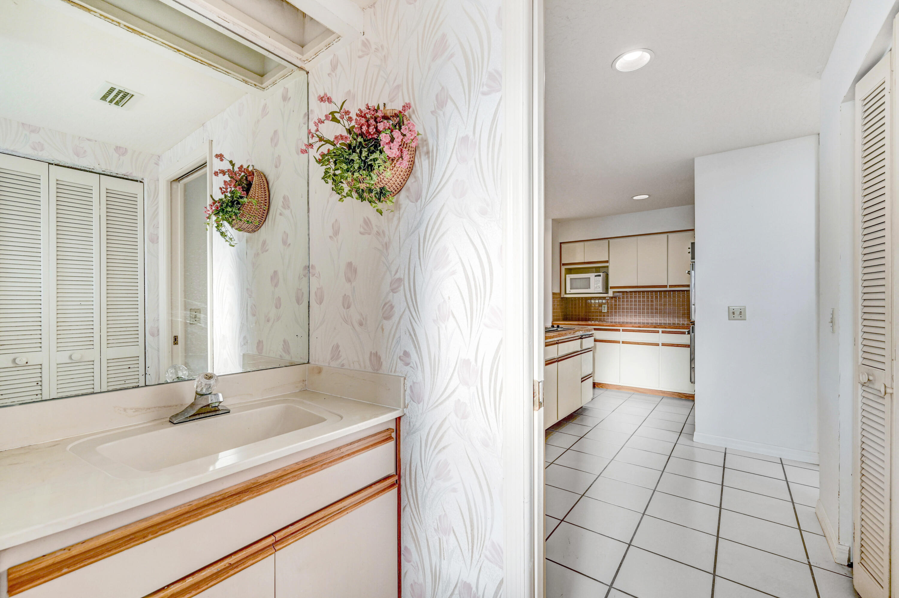 3 Inwood Way Indian Harbour Beach, FL 32937 - Photo 19 of 35 a bathroom with a sink a vanity and a mirror