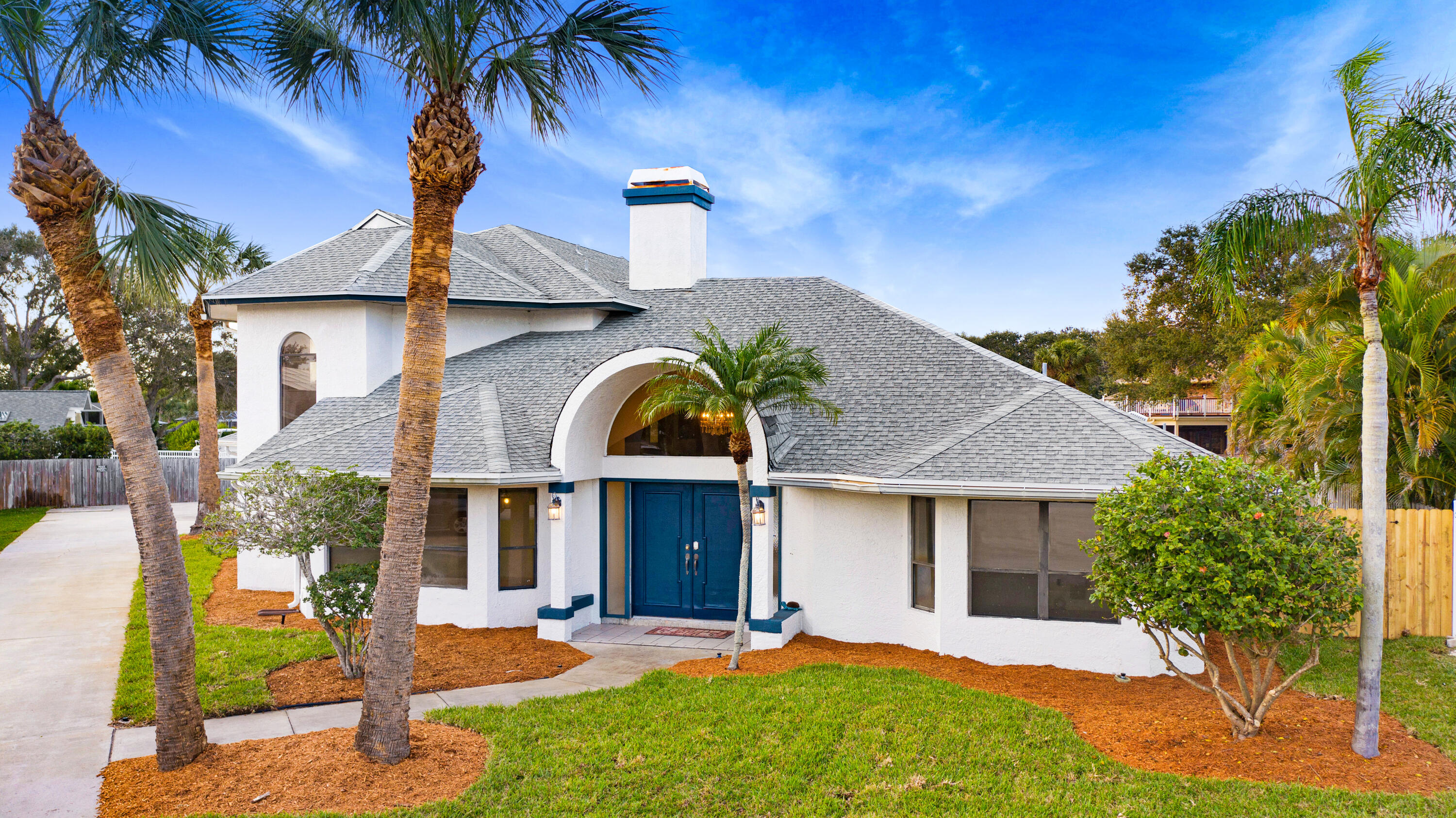 3 Inwood Way Indian Harbour Beach, FL 32937 - Photo 2 of 35 a front view of a house with garden and patio