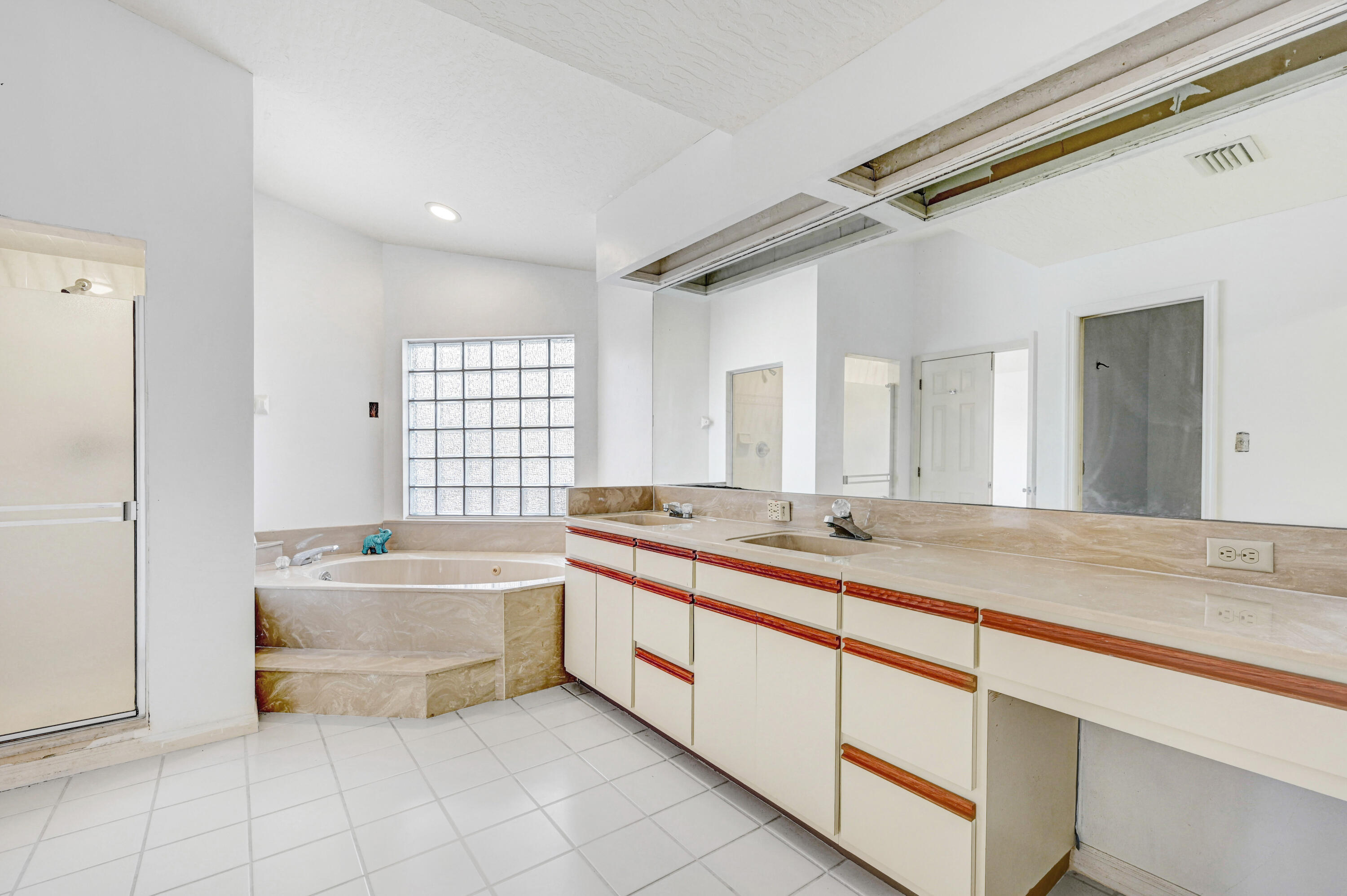 3 Inwood Way Indian Harbour Beach, FL 32937 - Photo 23 of 35 a bathroom with a granite countertop sink mirror bathtub and double