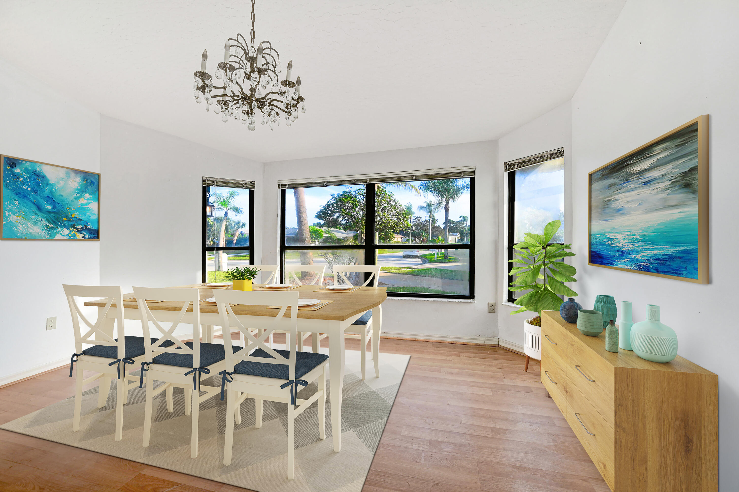 3 Inwood Way Indian Harbour Beach, FL 32937 - Photo 10 of 35 a view of a dining room with furniture large windows and wooden floor