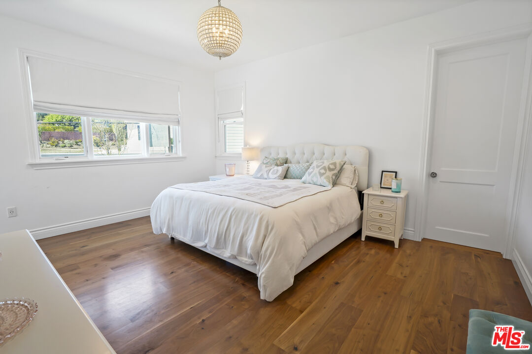 6544 Wandermere Road Malibu, CA 90265 - Photo 22 of 36 a bedroom with a bed and a window