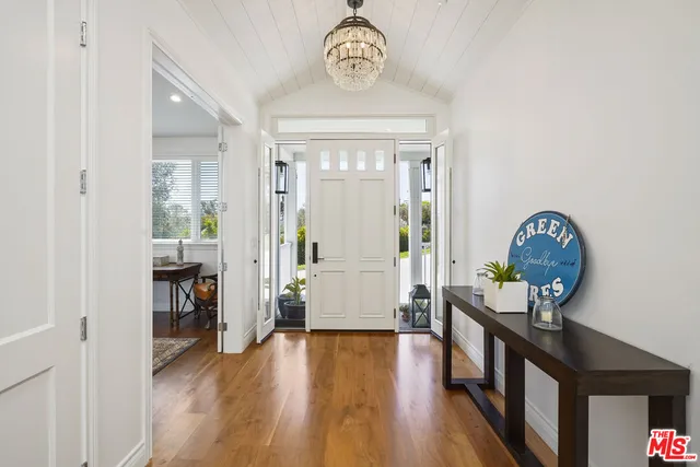 a lobby with furniture and a chandelier