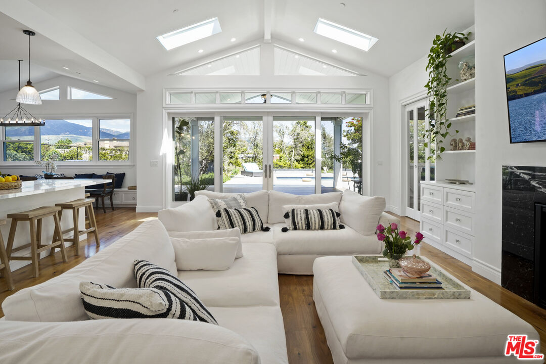 6544 Wandermere Road Malibu, CA 90265 - Photo 7 of 36 a living room with furniture and a large window