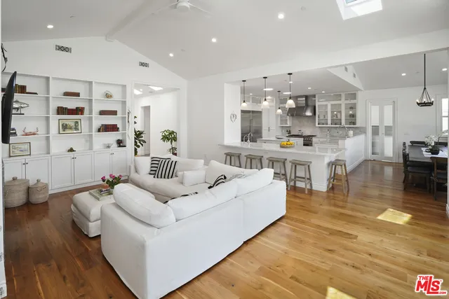 a kitchen with counter top space cabinets and wooden floor