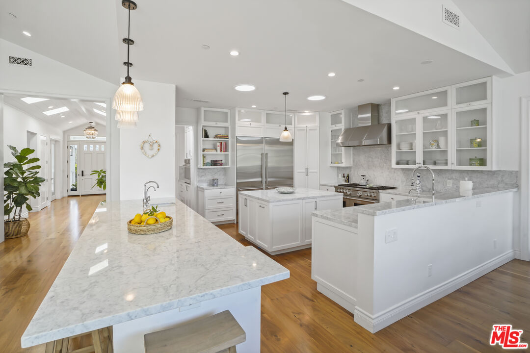 6544 Wandermere Road Malibu, CA 90265 - Photo 9 of 36 a kitchen with counter top space cabinets and wooden floor