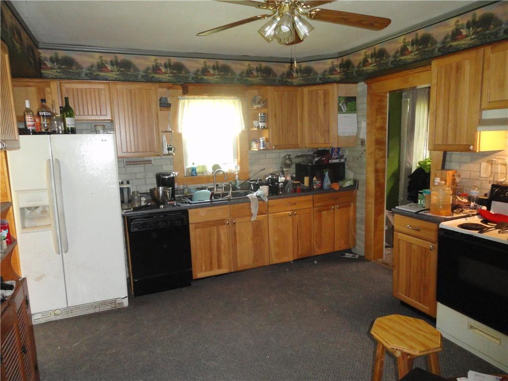 451 Mercer Road Greenville, PA 16125 - Photo 4 of 14 a kitchen with a refrigerator and a sink