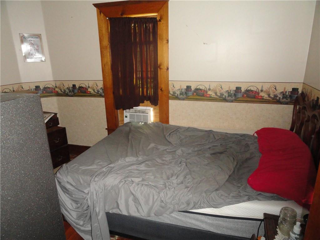 451 Mercer Road Greenville, PA 16125 - Photo 9 of 14 a bed sitting in a bedroom next to a cabinet