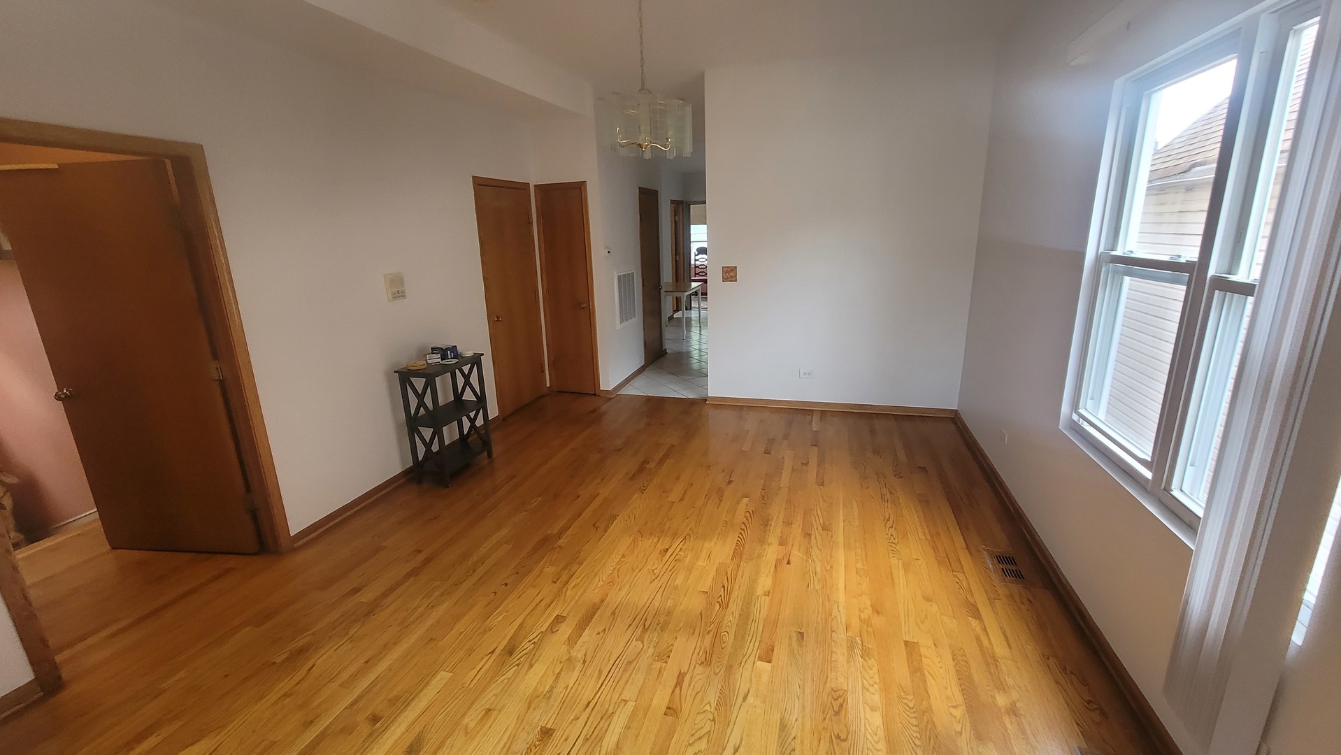 2977 North Lawndale Avenue, Unit 2 Chicago, IL 60618 - Photo 4 of 15 a view of a room with wooden floor and window