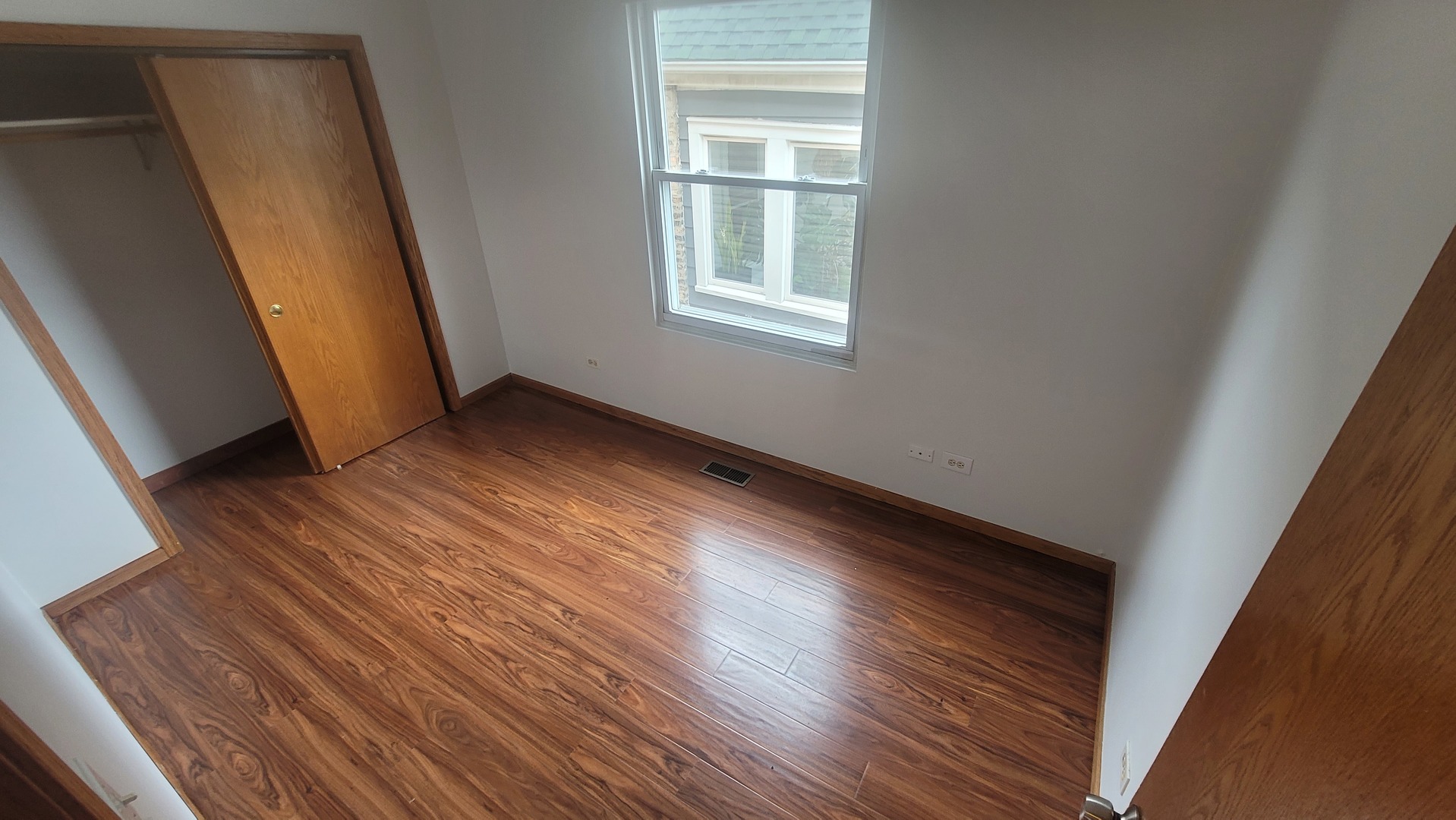 2977 North Lawndale Avenue, Unit 2 Chicago, IL 60618 - Photo 6 of 15 a view of a room with wooden floor and window