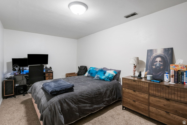 41 Benchmark Village Tooele, UT 84074 - Photo 19 of 26 Bedroom with light carpet and a desk