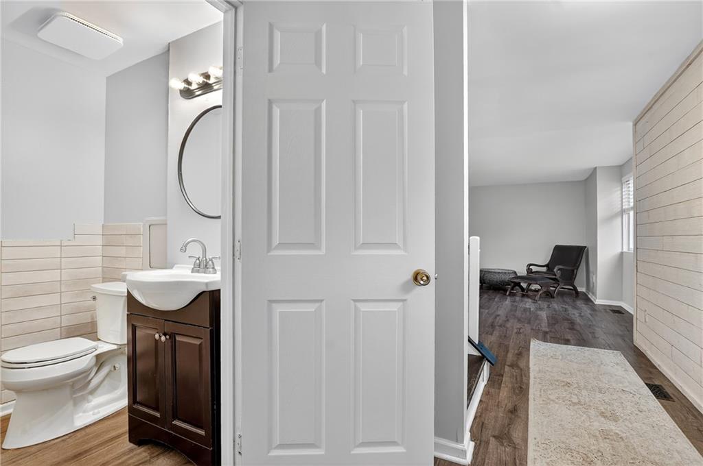 1240 Manor Drive Upper St. Clair, PA 15241 - Photo 12 of 24 a bathroom with a sink a toilet and a mirror