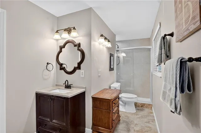 a bathroom with a toilet sink and mirror