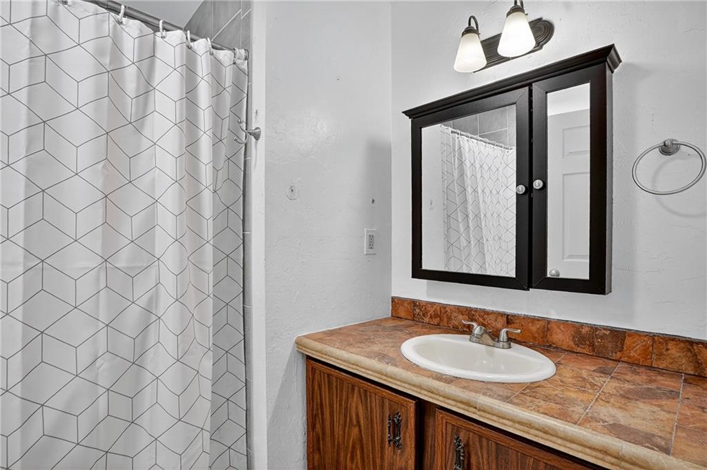 1240 Manor Drive Upper St. Clair, PA 15241 - Photo 18 of 24 a bathroom with a sink and a mirror