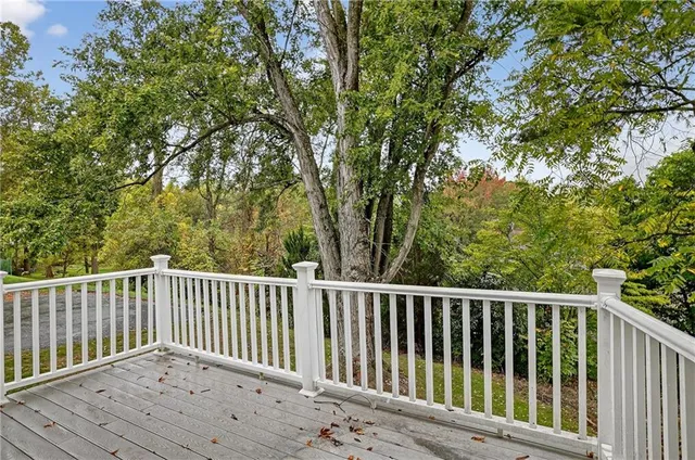 a balcony with wooden floor and fence
