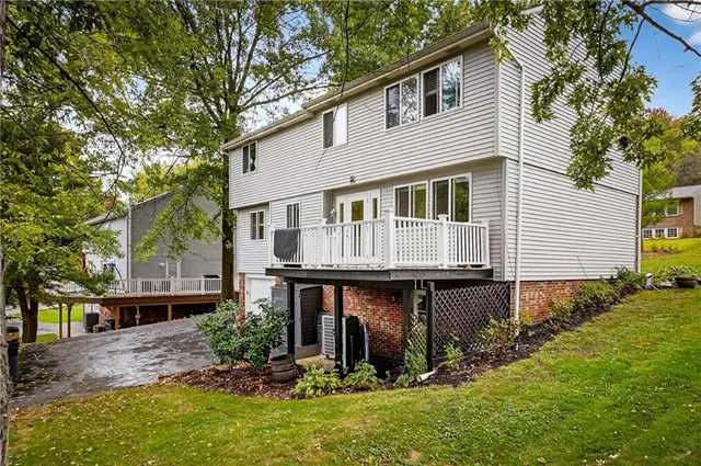 a view of house with yard and sitting area