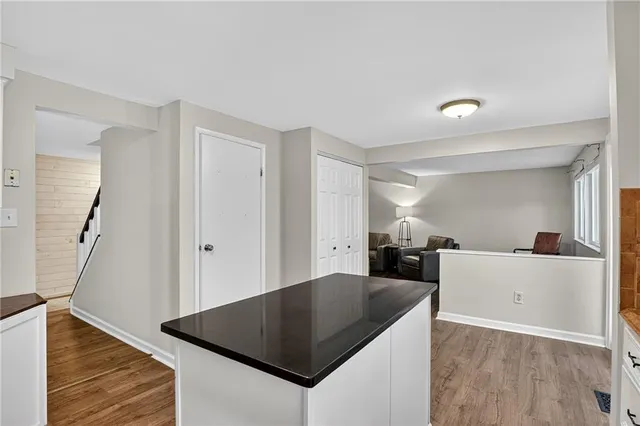 a kitchen with cabinets and wooden floor