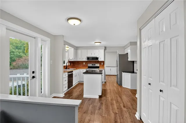 a kitchen with a refrigerator and a stove top oven
