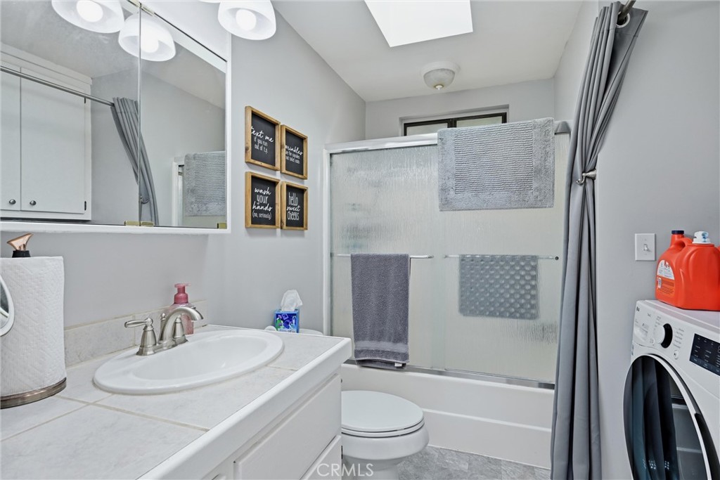 20257 Indian Rock Road Hidden Valley Lake, CA 95467 - Photo 9 of 33 Hall bathroom has shower over tub and laundry in the closet.