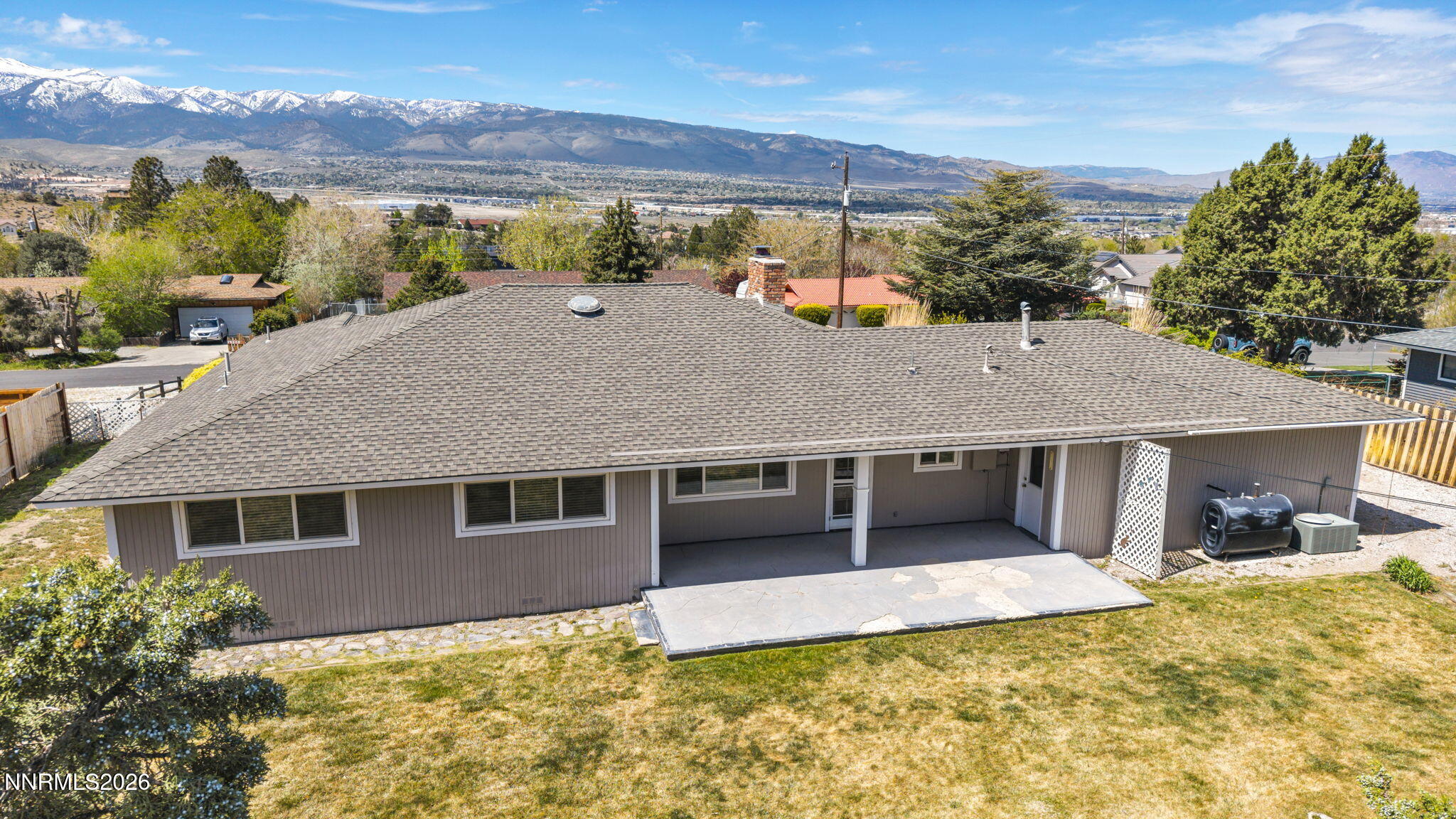 14190 Rim Rock Drive Reno, NV 89521 - Photo 62 of 68 a view of a house with a large window and a yard