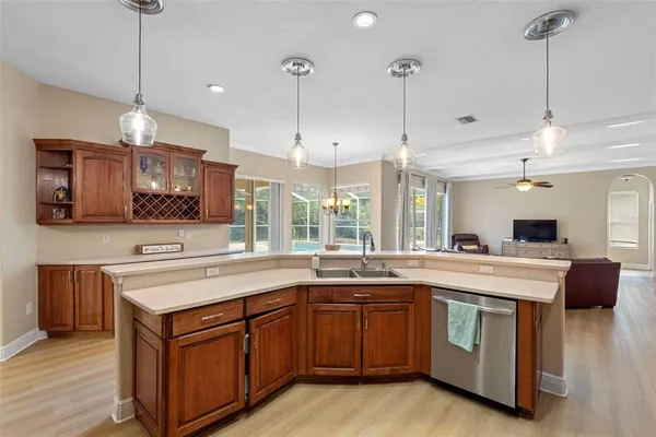 a kitchen with a sink stove and wooden floor