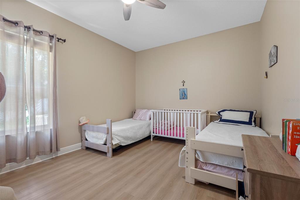 121 Myrtle Ridge Road Lutz, FL 33549 - Photo 23 of 42 a bedroom with furniture and a window