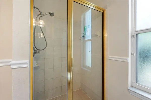 a bathroom with a glass shower door