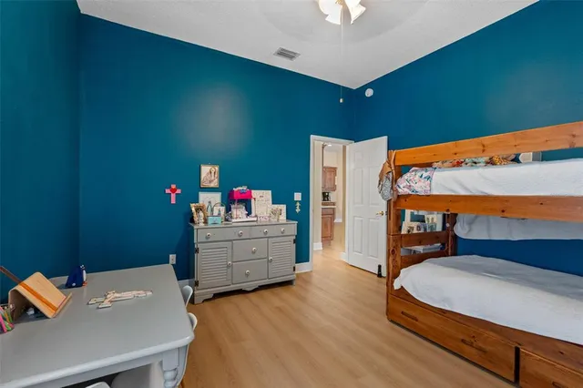 a bedroom with a bed and wooden floor