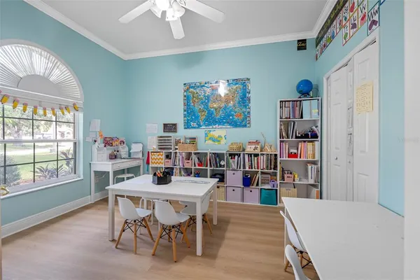 a work room with furniture and a bookshelf