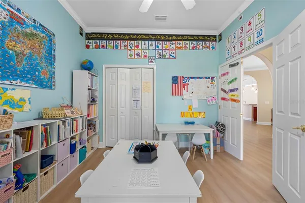 a bedroom with furniture and a book shelf