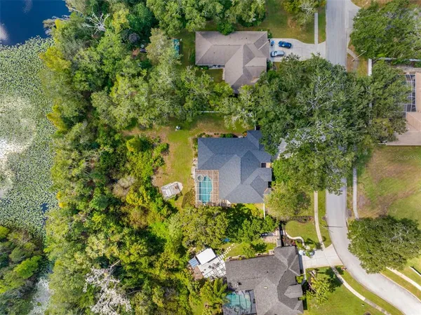 an aerial view of a house with a yard