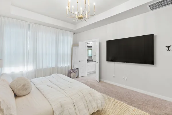 a bedroom with a bed and a flat screen tv