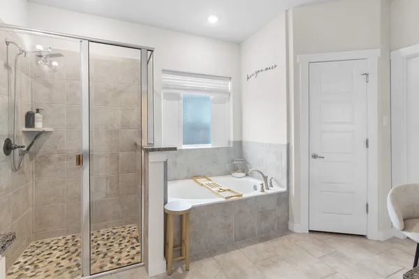 a bathroom with a tub a sink and a shower