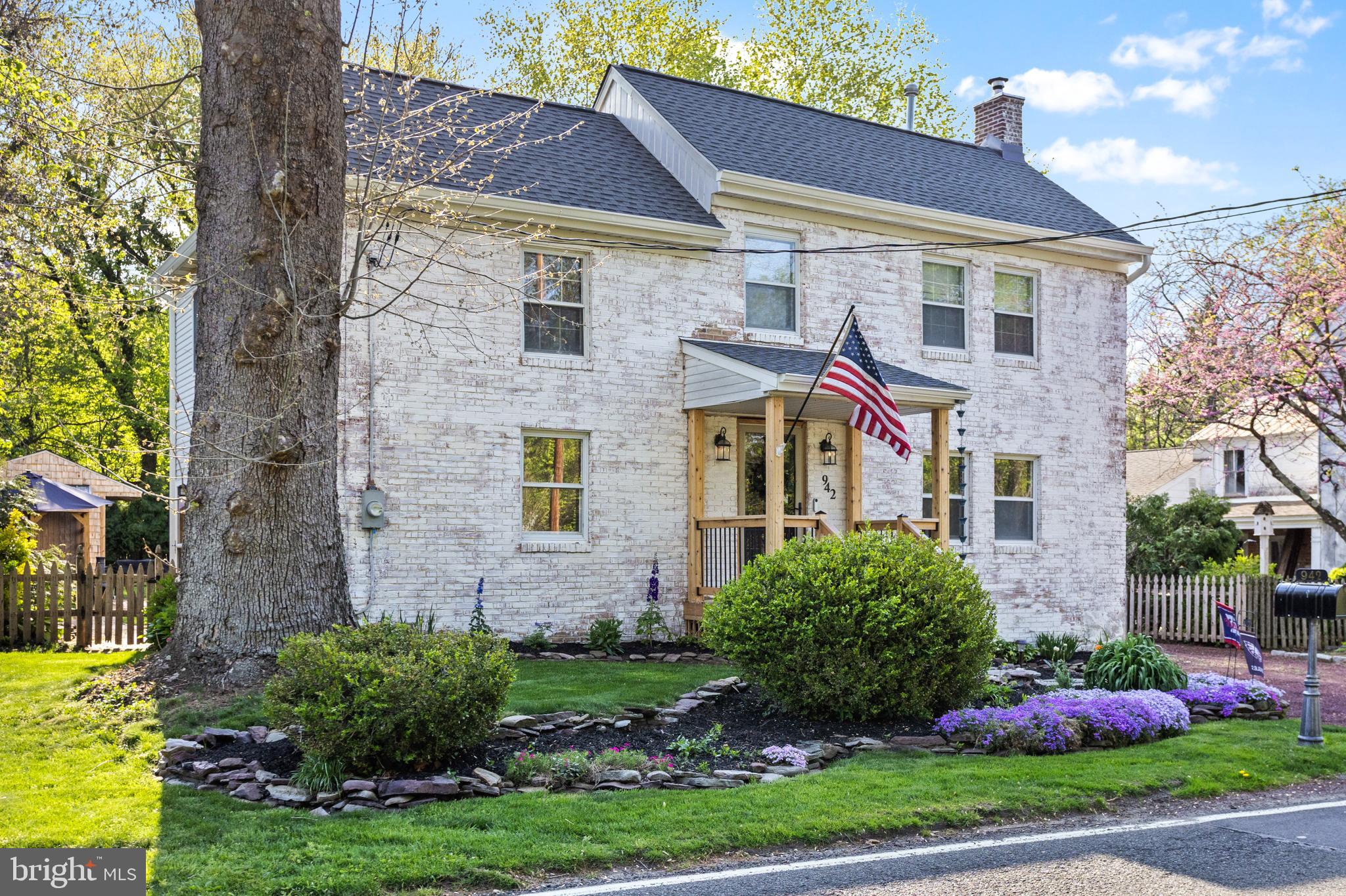942 Province Line Road Allentown, NJ 08501 - Photo 2 of 50 a view of a brick house with a yard plants and a large tree