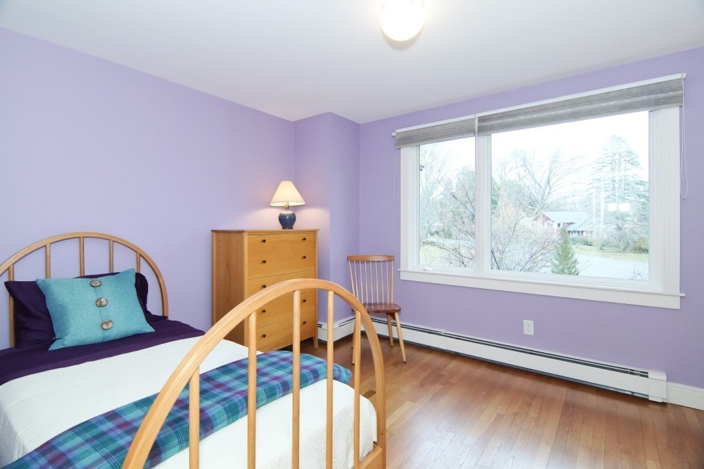 9 Saddle Club Road Lexington, MA 02420 - Photo 12 of 25 a view of a bedroom with furniture and a window