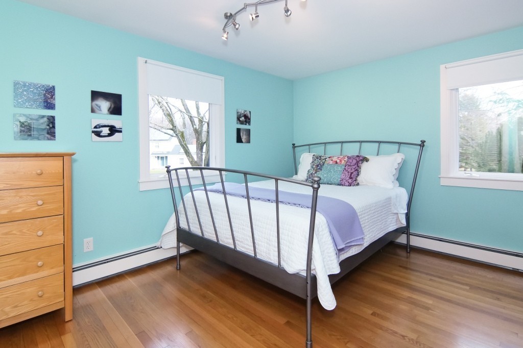 9 Saddle Club Road Lexington, MA 02420 - Photo 10 of 25 a bed sitting in a bedroom next to a window