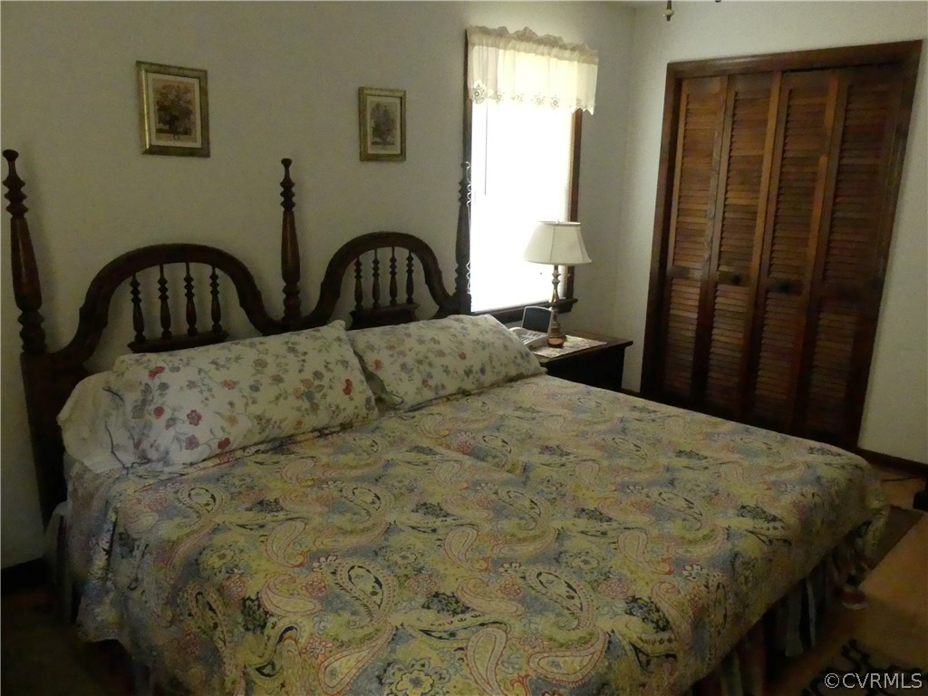 1876 Scotts Bottom Road Dillwyn, VA 23936 - Photo 12 of 30 a bed sitting in a bedroom next to a window