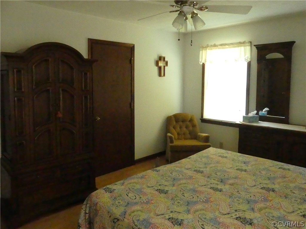 1876 Scotts Bottom Road Dillwyn, VA 23936 - Photo 13 of 30 a bedroom with a bed and a chandelier