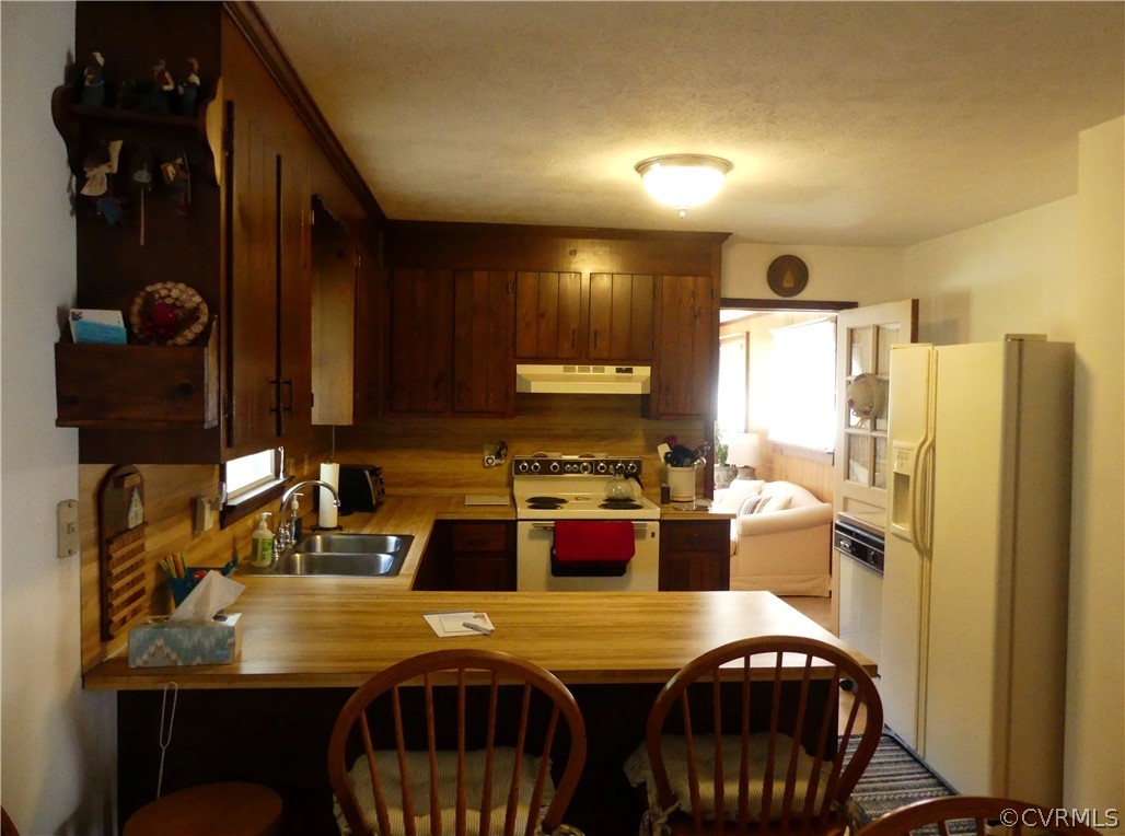 1876 Scotts Bottom Road Dillwyn, VA 23936 - Photo 10 of 30 a kitchen with a refrigerator and a stove top oven