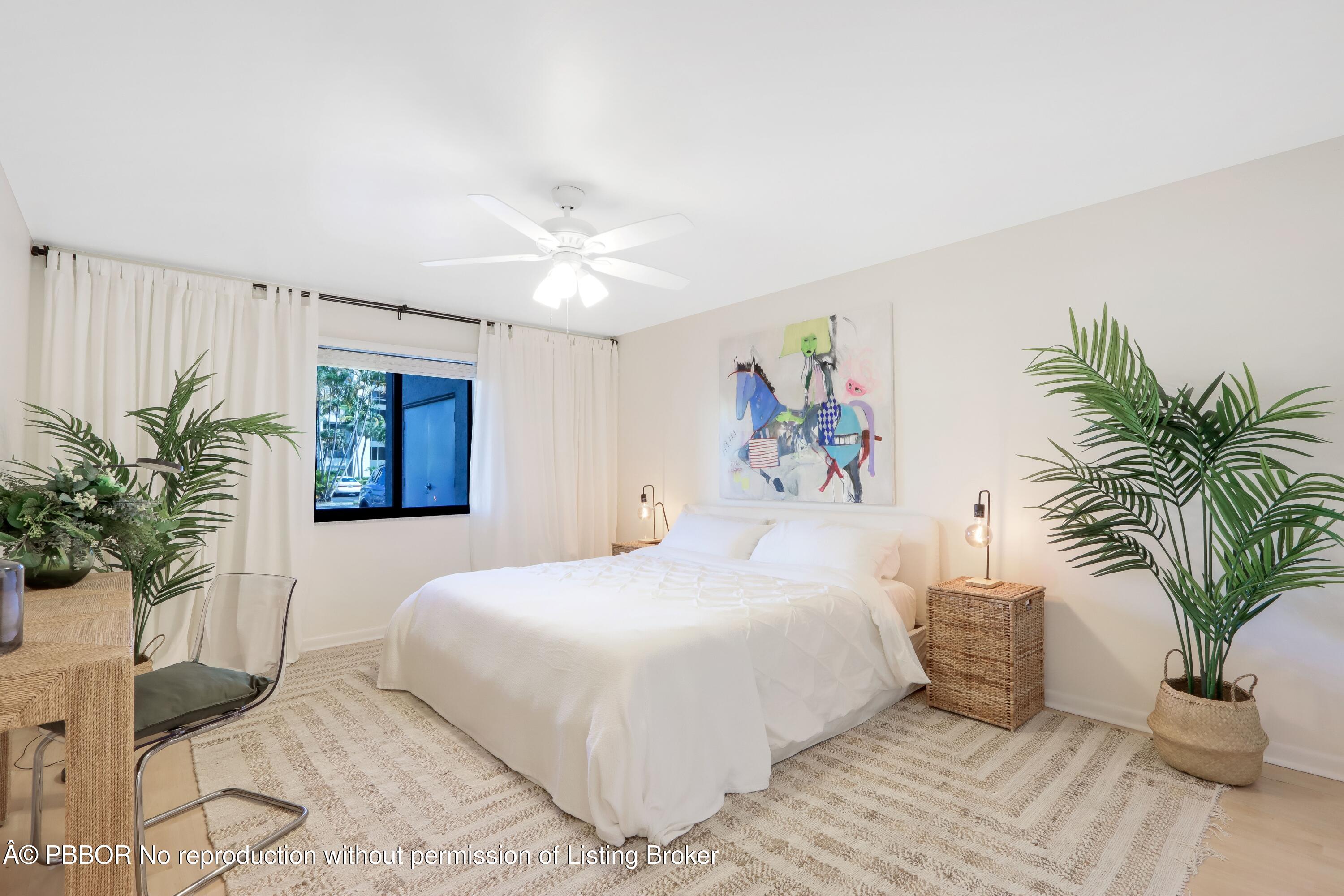 3525 South Ocean Boulevard, Unit 108 Palm Beach, FL 33480 - Photo 11 of 13 a bedroom with a large bed and a potted plant