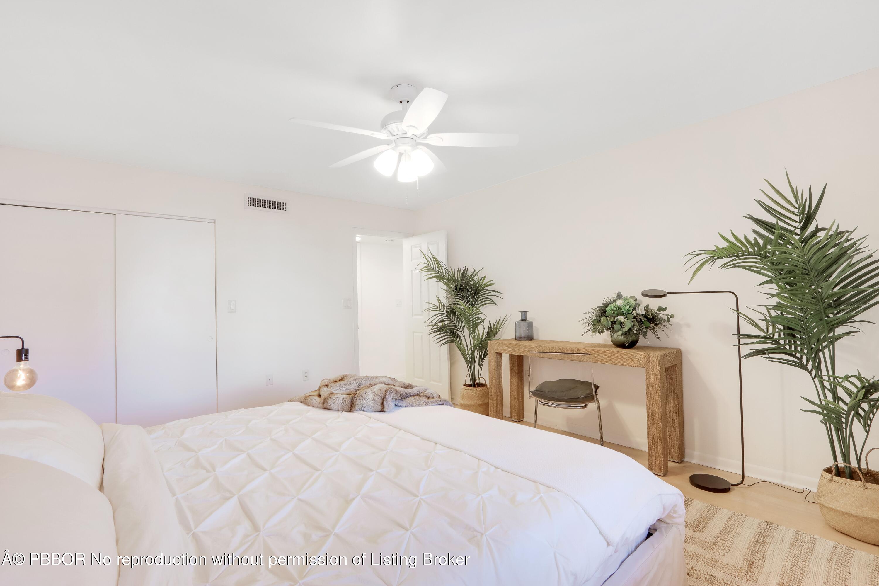 3525 South Ocean Boulevard, Unit 108 Palm Beach, FL 33480 - Photo 12 of 13 a bedroom with a bed and a chandelier