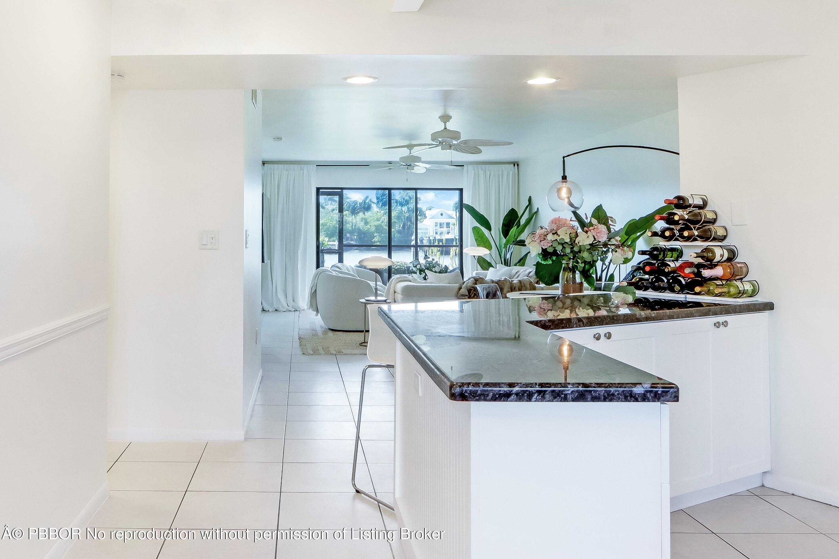 3525 South Ocean Boulevard, Unit 108 Palm Beach, FL 33480 - Photo 3 of 13 a kitchen with a table and chairs in it
