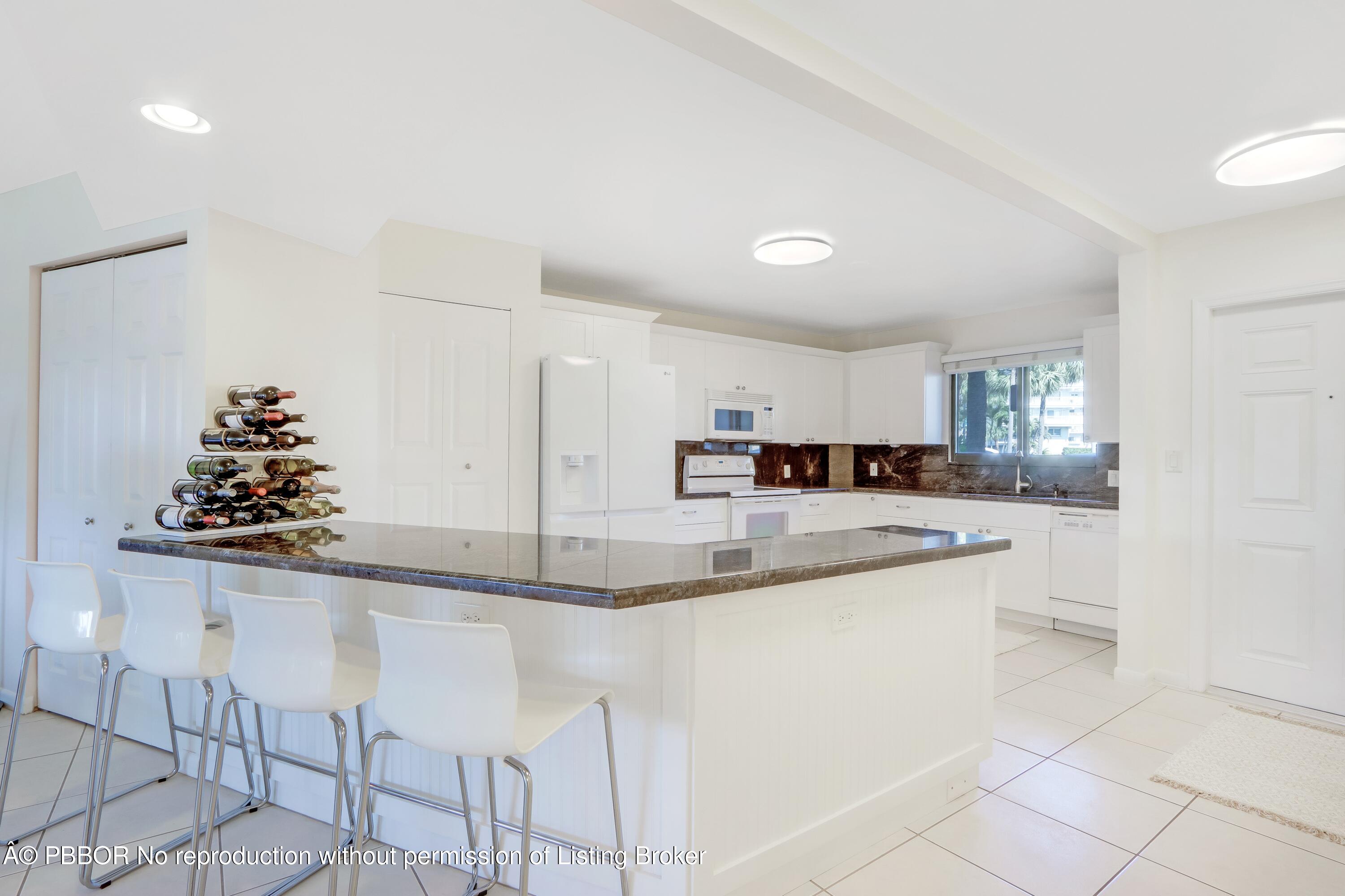 3525 South Ocean Boulevard, Unit 108 Palm Beach, FL 33480 - Photo 4 of 13 a kitchen with stainless steel appliances granite countertop a sink and cabinets