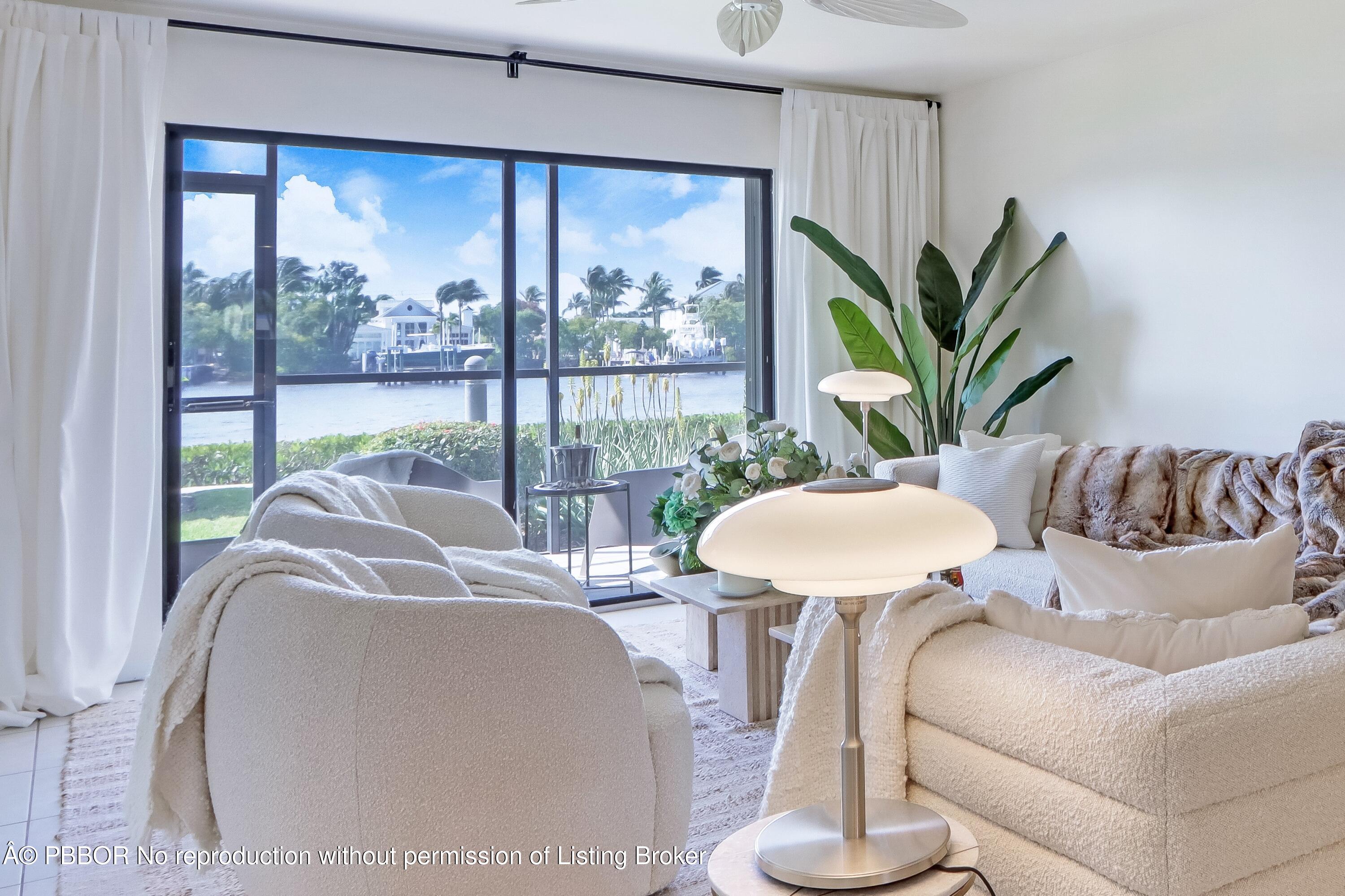 3525 South Ocean Boulevard, Unit 108 Palm Beach, FL 33480 - Photo 7 of 13 a living room with couches and a large window