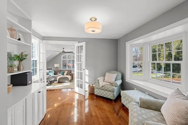 a bedroom with a large bed flat screen tv and a large window