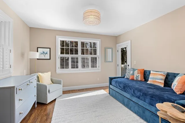 a bathroom with a tub a window and a shower